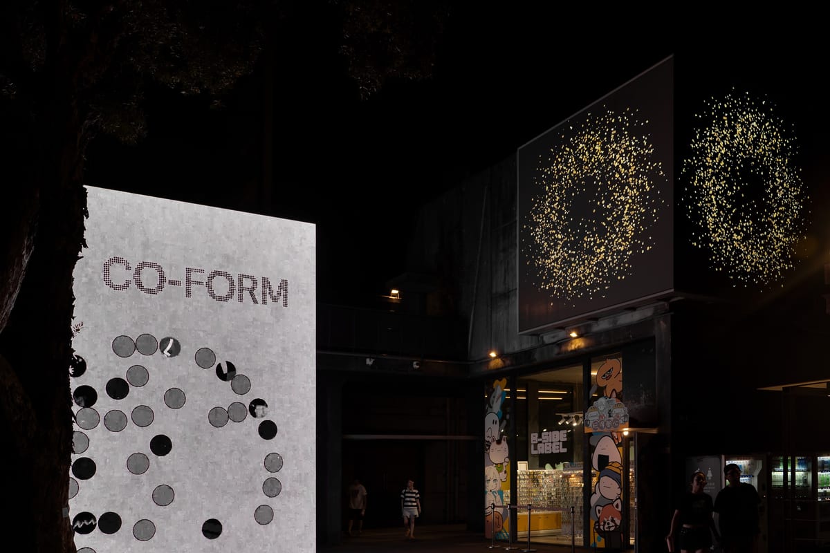 CO-FORM fills Huashan's illuminated outer screens after dark, with visitors crossing the park below.