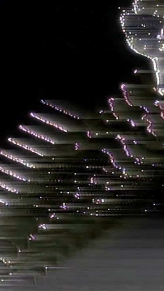 A vertical field of fractured light and image noise.
