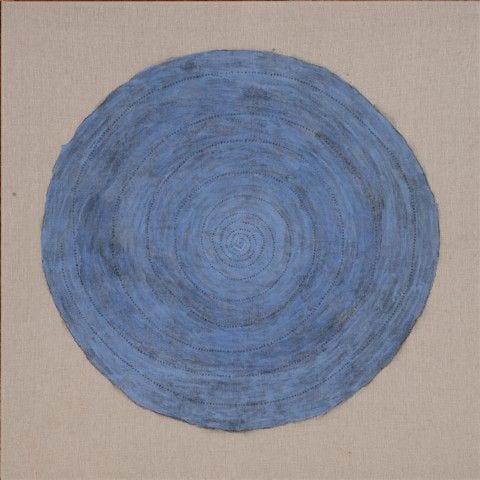 A blue circular field built in layers of mineral pigment on linen, with fine script running through it.