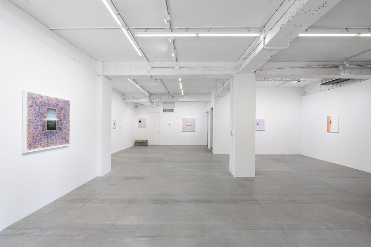 A long white gallery with The Edge of Light at left and smaller paintings distributed across the remaining walls.