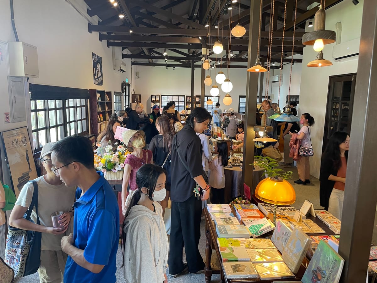 Pendant lamps and book displays in the timber house on opening day.